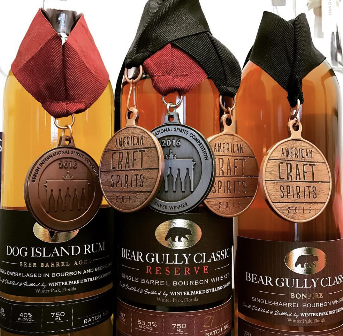 Competition medals hanging on Dog Island and Bear Gully Classic bottles